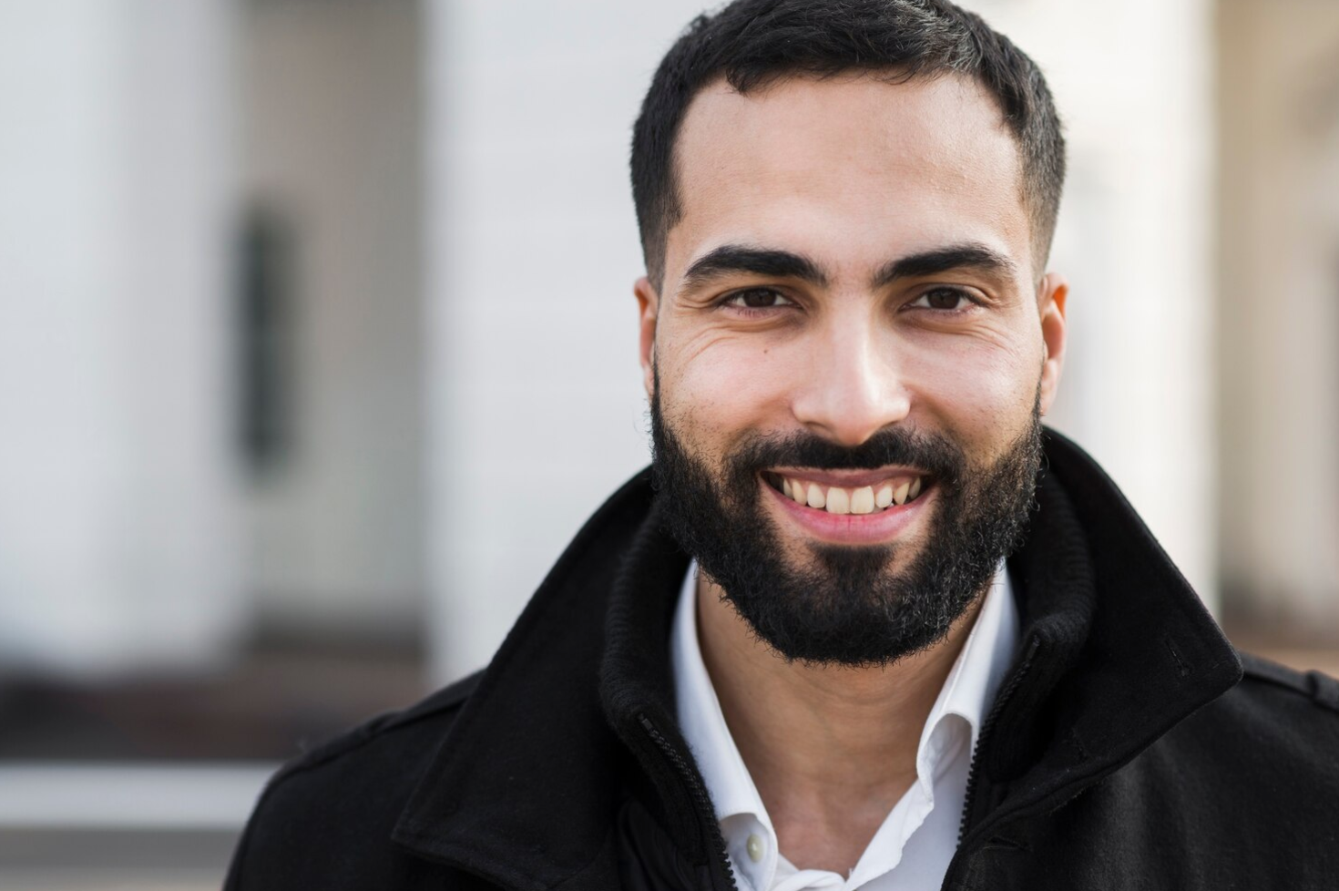 Homme avec une barbe soignée souriant